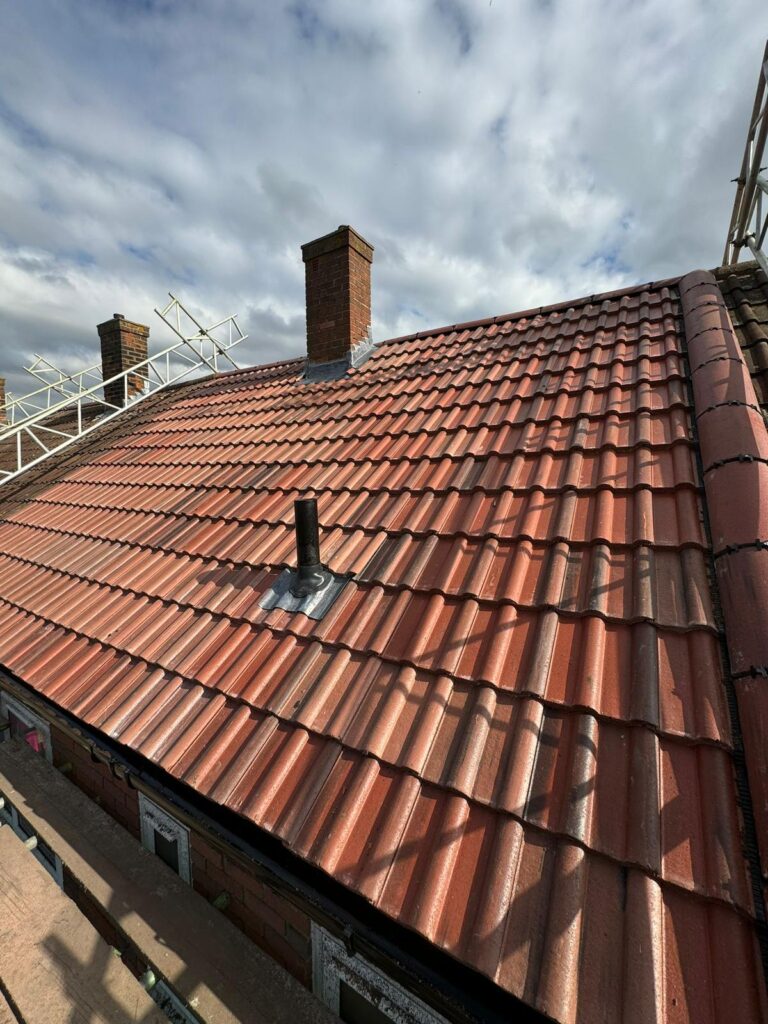 Pitched Roofing 5 Newly installed tiled roof with chimneys and ventilation pipe, showcasing checka roof ltd's expertise in london, essex & kent.