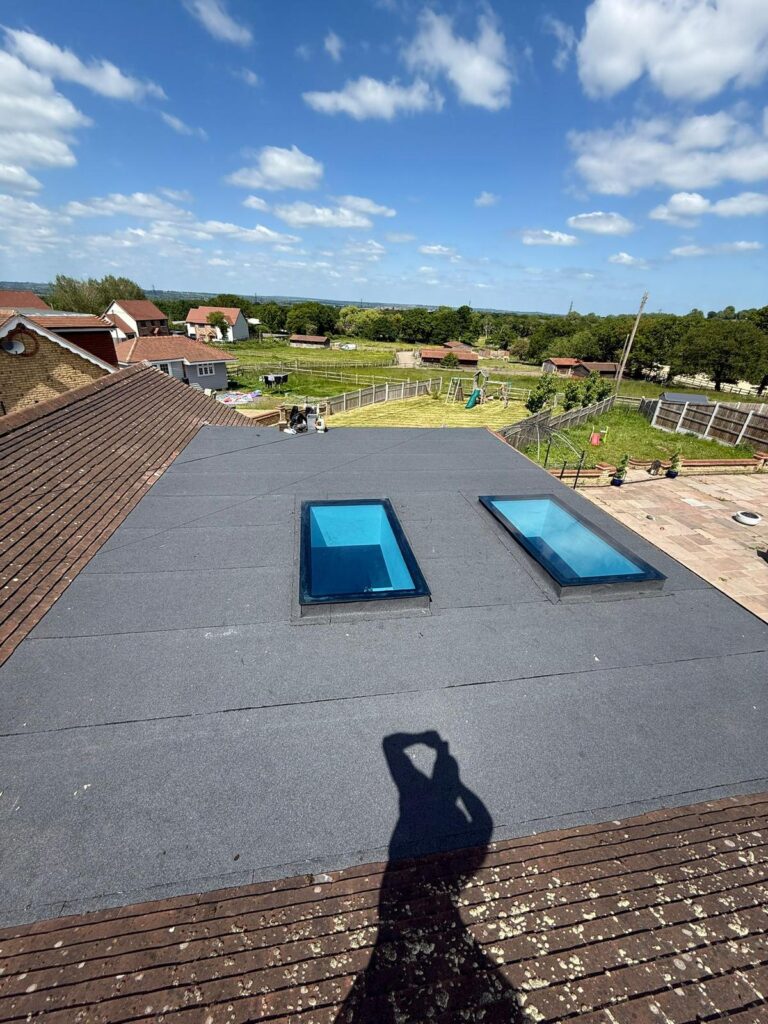 Velux / Roof Windows 3 Expansive flat roof installation with two large skylights, offering panoramic views and natural light, by checka roof ltd in kent, essex, or london.