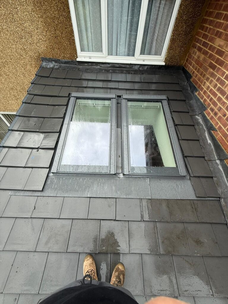 Velux / Roof Windows 4 New dark grey tiled roof installation with integrated skylights, showcasing checka roof ltd's work in london, essex, and kent.