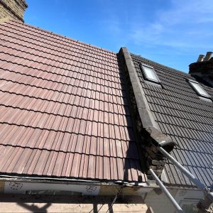 Velux / Roof Windows 11 Roof renovation in progress, showing new and existing roof tiles with velux windows, by checka roof ltd.