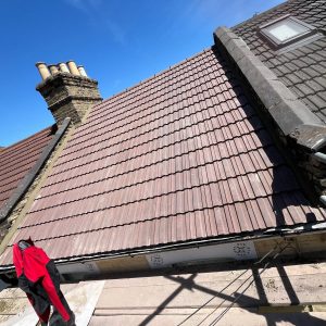 Chimney And Leadwork 14 Roof replacement project by checka roof ltd, showing a blend of old and new tiles, chimney, and skylight during construction in london, essex, or kent.