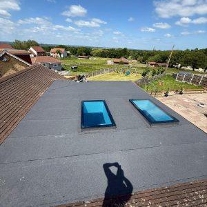 Velux / Roof Windows 7 Expansive flat roof installation with two large skylights, offering panoramic views and natural light, by checka roof ltd in kent, essex, or london.