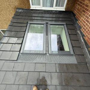 Velux / Roof Windows 10 New dark grey tiled roof installation with integrated skylights, showcasing checka roof ltd's work in london, essex, and kent.